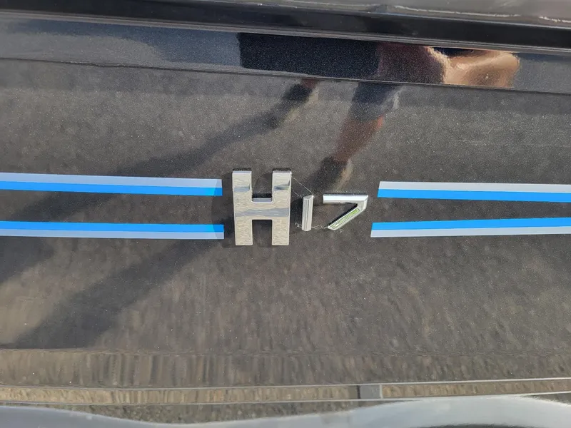 Slide: The Image of 2025 Xpress H17C Crappie boat logo with blue stripes. - 9