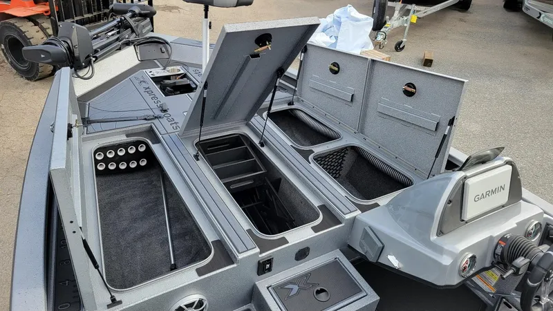 Slide: The Image of 2025 Xpress X19 Pro boat interior with storage compartments and Garmin equipment. - 5