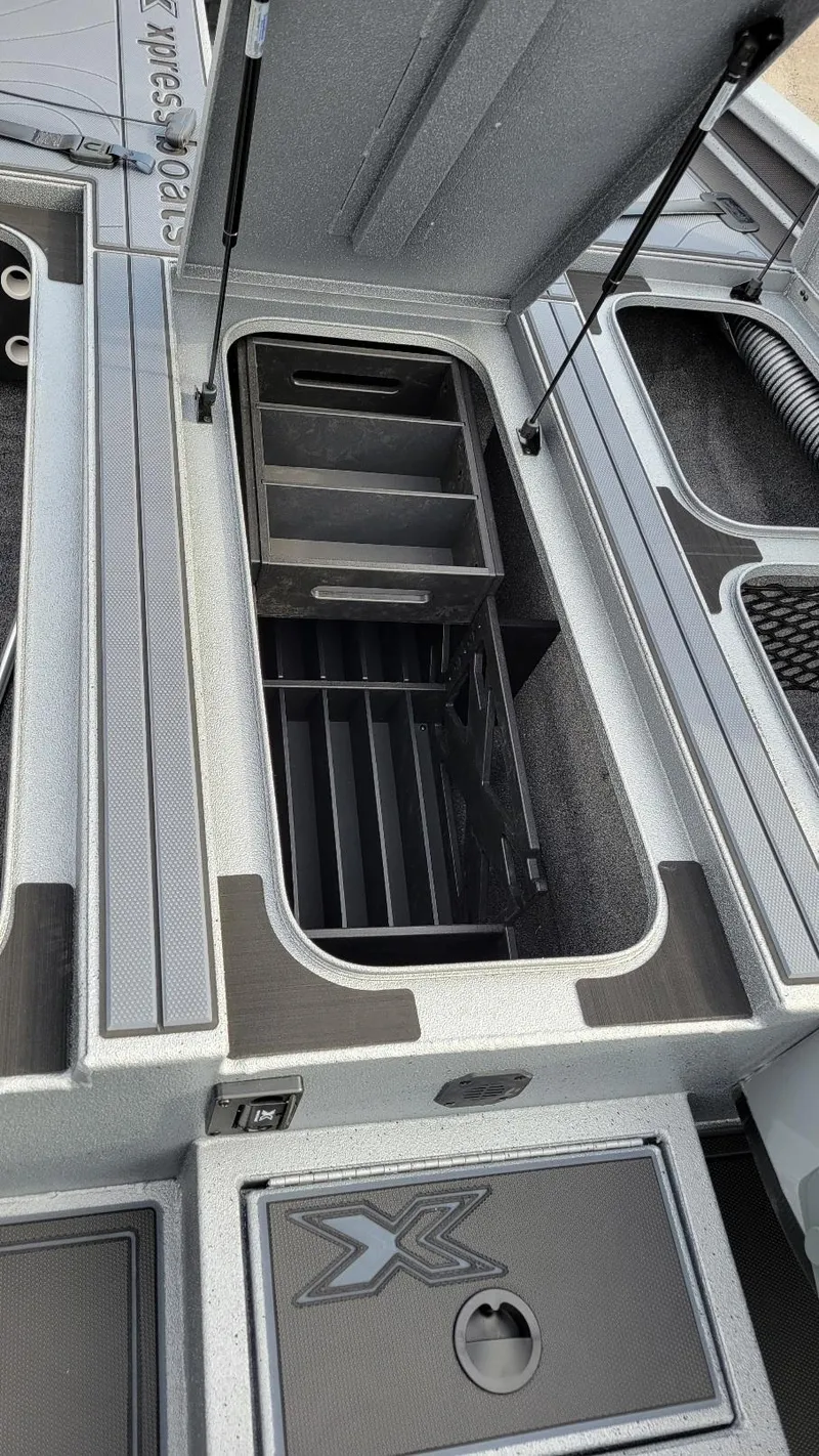 Slide: The Image of 2025 Xpress X19 Pro boat storage compartment with organized shelving. - 6