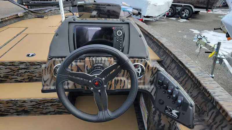 Slide: The Image of 2025 Xpress H17 Bass boat dashboard with steering wheel and control panel. - 12