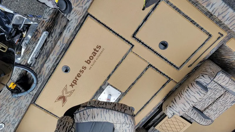 Slide: The Image of 2025 Xpress H17 Bass boat interior with Yamaha Vmax 90 SHO engine, featuring storage compartments. - 17