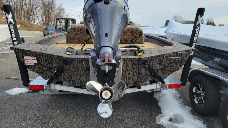 Slide: The Image of 2025 Xpress H17 Bass boat with Yamaha Vmax 90 SHO engine, camo design, on trailer. - 3