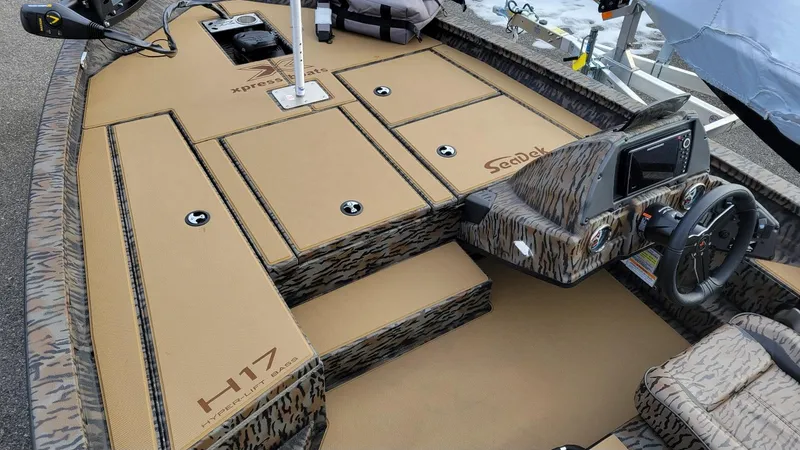 Slide: The Image of 2025 Xpress H17 Bass boat interior with Yamaha Vmax 90 SHO, featuring camo design and SeaDek flooring. - 5