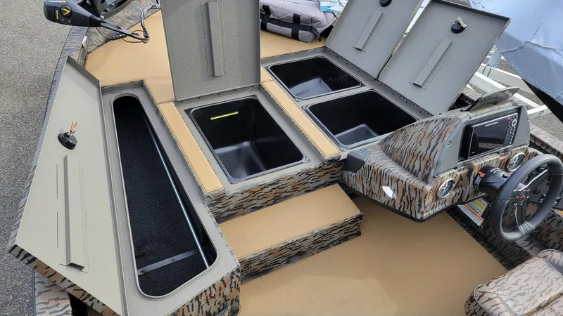Slide: The Image of 2025 Xpress H17 Bass boat interior with storage compartments and steering console. - 8