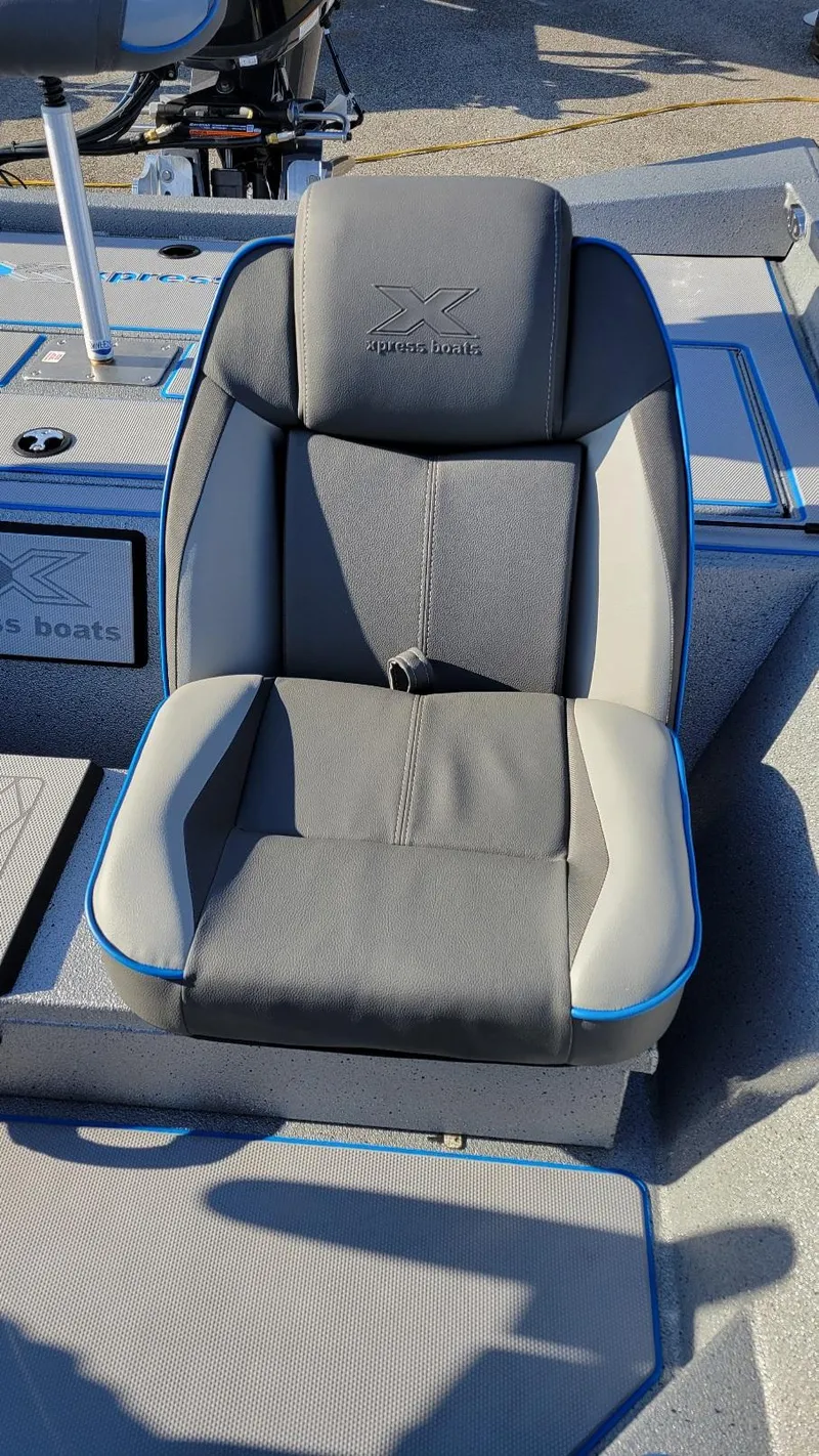 Slide: The Image of 2025 Xpress H17 Bass boat seat with gray and blue accents. - 11