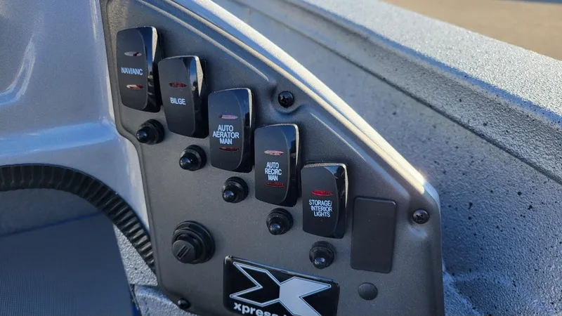 Slide: The Image of Control panel of 2025 Xpress H17 Bass boat with labeled switches. - 5