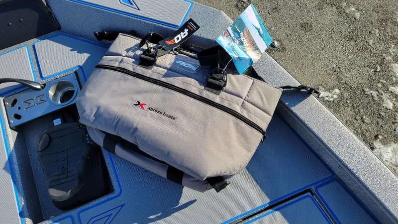 Slide: The Image of Bag on Xpress H17 Bass boat deck, showcasing accessories and branding. - 8