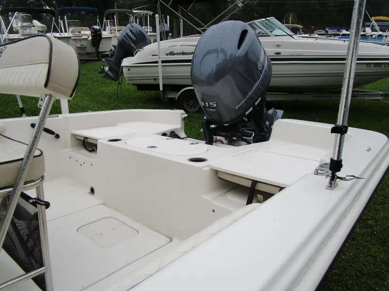 Slide: The Image of 2022 Carolina Skiff 19 LS boat with Yamaha outboard motor, displayed on grass. - 2