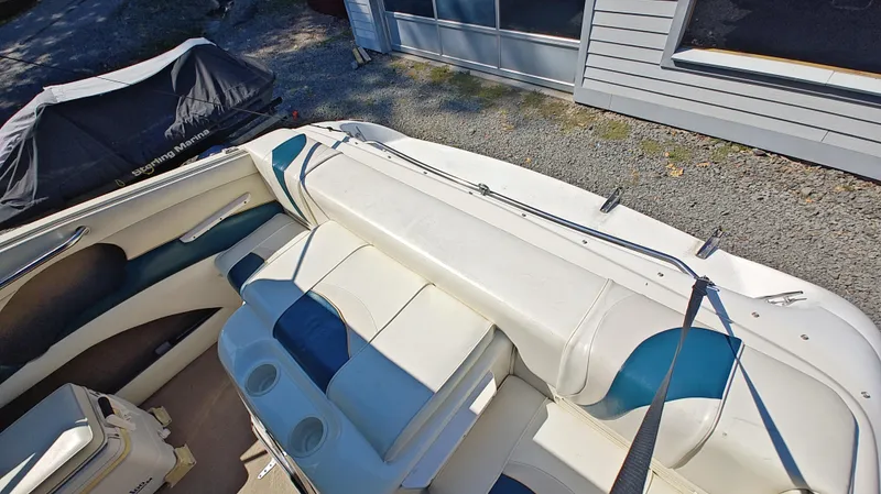 Slide: The Image of 1997 Rinker Festiva 212 boat interior with white and blue seating. - 10
