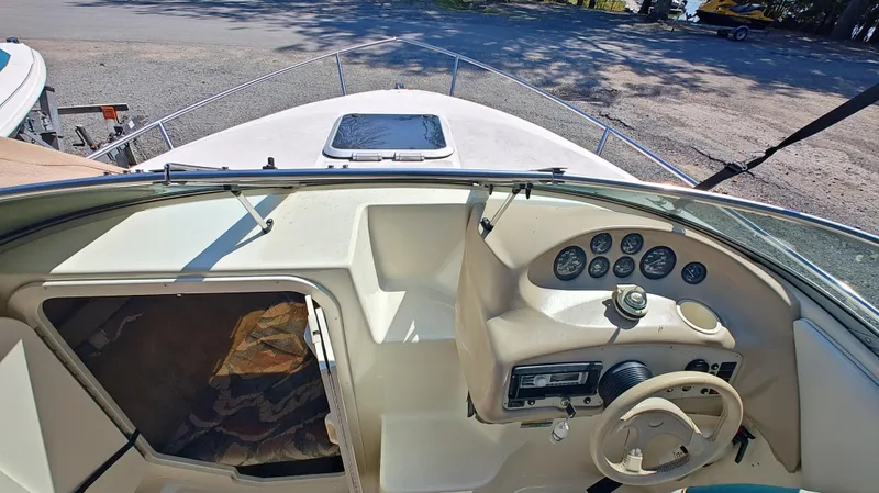 Slide: The Image of 1997 Rinker Festiva 212 boat interior with steering wheel and dashboard controls. - 12