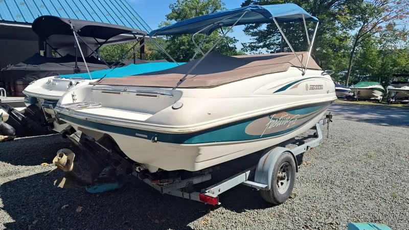 Slide: The Image of 1997 Rinker Festiva 212 boat on trailer, parked outdoors. - 4
