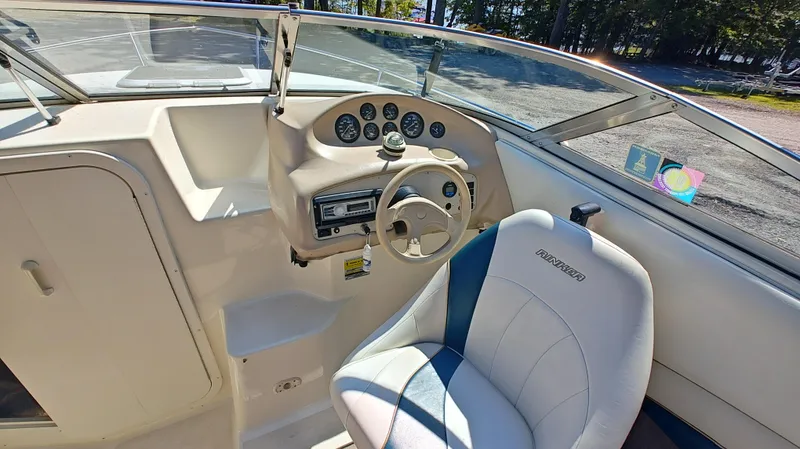 Slide: The Image of 1997 Rinker Festiva 212 boat interior with steering wheel and dashboard. - 6