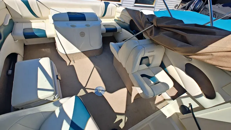 Slide: The Image of 1997 Rinker Festiva 212 boat interior with white and blue seating. - 8