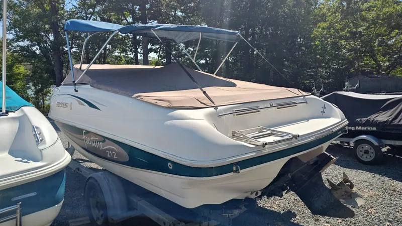Slide: The Image of 1997 Rinker Festiva 212 boat on trailer, covered, in outdoor storage. - 9