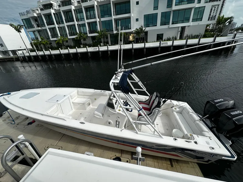 The Image of 2001 Concept 30 PF Sport boat docked by modern waterfront buildings. - 0