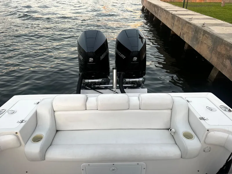 Slide: The Image of 2001 Concept 30 PF Sport boat with twin Mercury engines, white seating, docked by water. - 3
