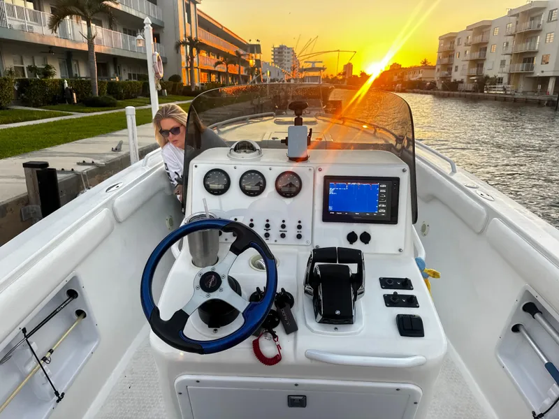 Slide: The Image of Concept 30 PF Sport 2001 boat at sunset, featuring a modern dashboard and canal view. - 4