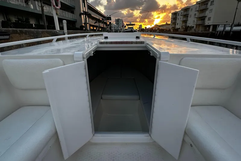 Slide: The Image of Open cabin of 2001 Concept 30 PF Sport boat at sunset, docked near buildings. - 6