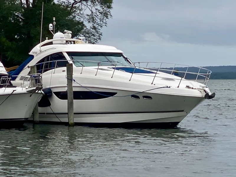 Slide: The Image of 2013 Sea Ray 580 Sundancer yacht docked on a calm lake. - 4