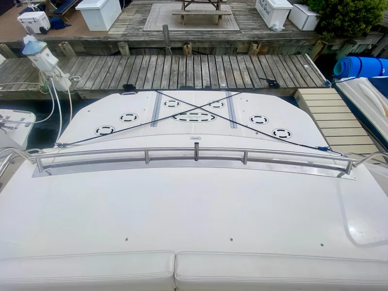 Slide: The Image of 2013 Sea Ray 580 Sundancer yacht docked at marina, view of stern and swim platform. - 23