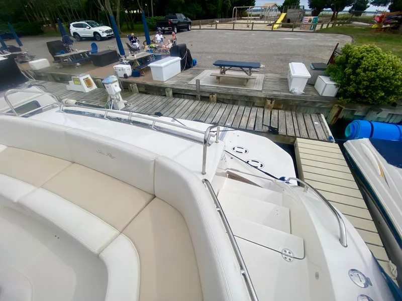 Slide: The Image of Sea Ray 580 Sundancer 2013 docked, featuring spacious seating and deck area. - 24