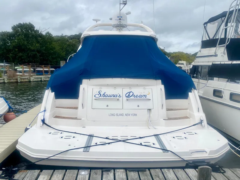 Slide: The Image of 2013 Sea Ray 580 Sundancer docked, featuring blue cover and "Shauna's Dream" nameplate. - 10