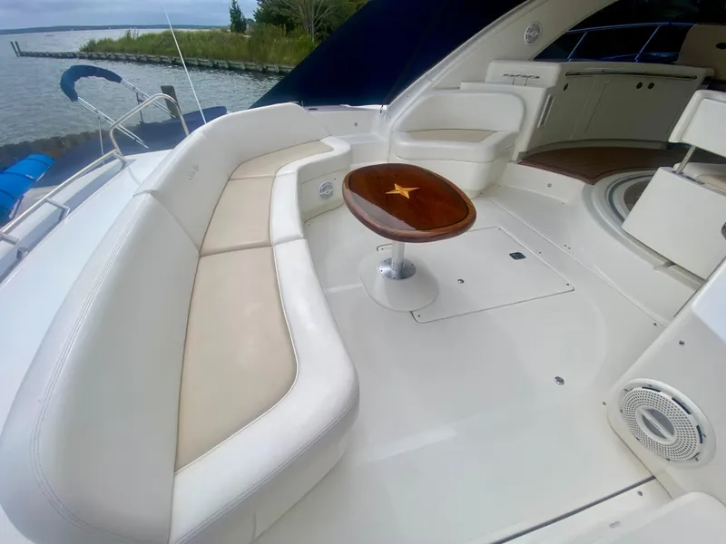 Slide: The Image of Luxurious 2013 Sea Ray 580 Sundancer yacht with elegant white seating and wooden table. - 29