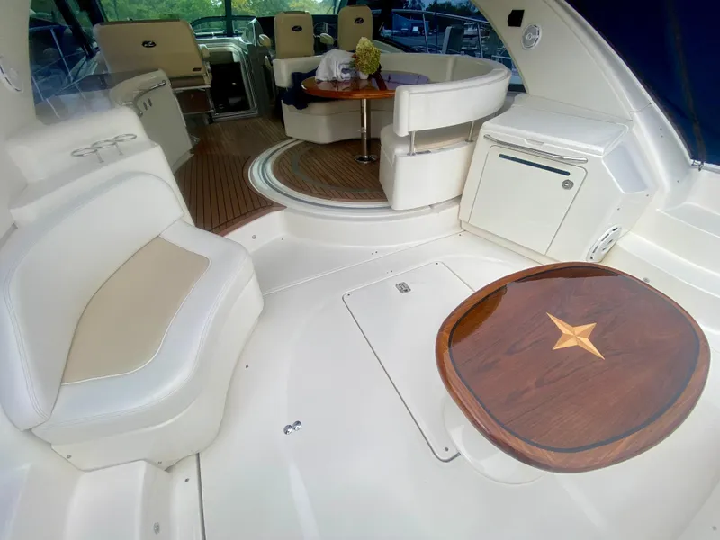 Slide: The Image of Luxurious interior of 2013 Sea Ray 580 Sundancer yacht with elegant seating and wooden table. - 20