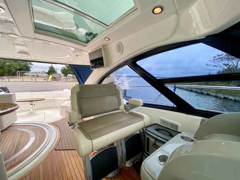 Slide: The Image of Luxurious 2013 Sea Ray 580 Sundancer yacht interior with elegant seating and panoramic windows. - 36