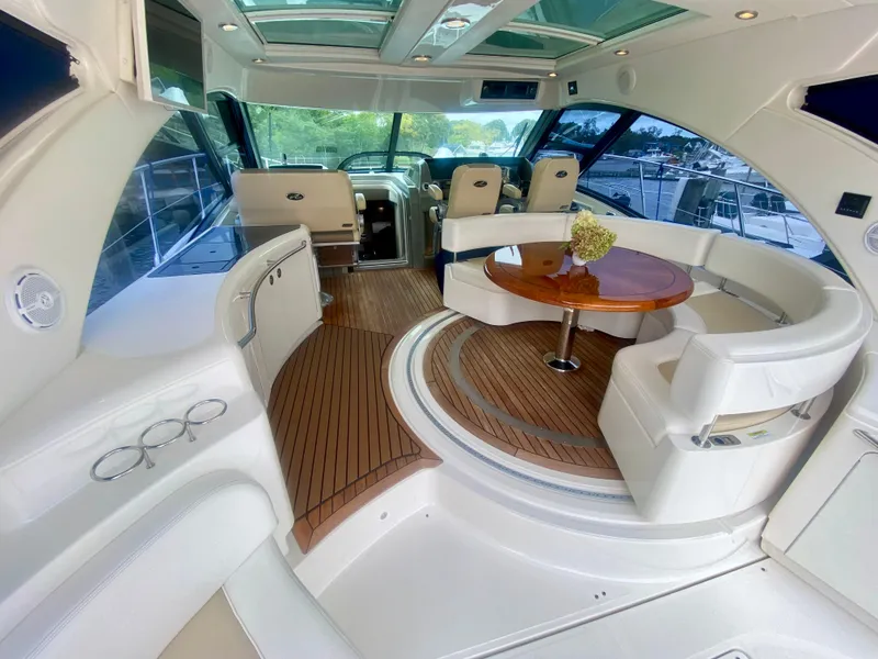 Slide: The Image of Luxurious 2013 Sea Ray 580 Sundancer yacht interior with elegant seating and wooden flooring. - 27
