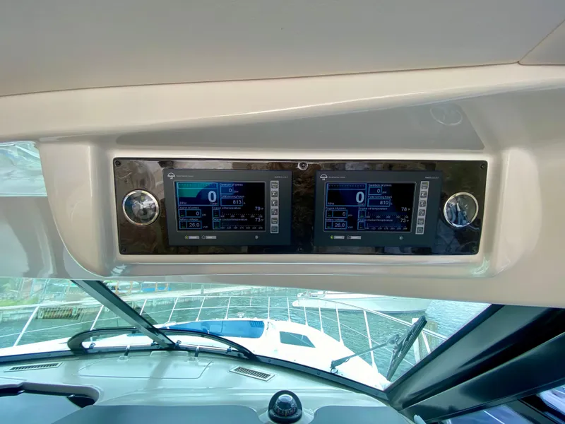 Slide: The Image of 2013 Sea Ray 580 Sundancer dashboard with dual electronic displays. - 49