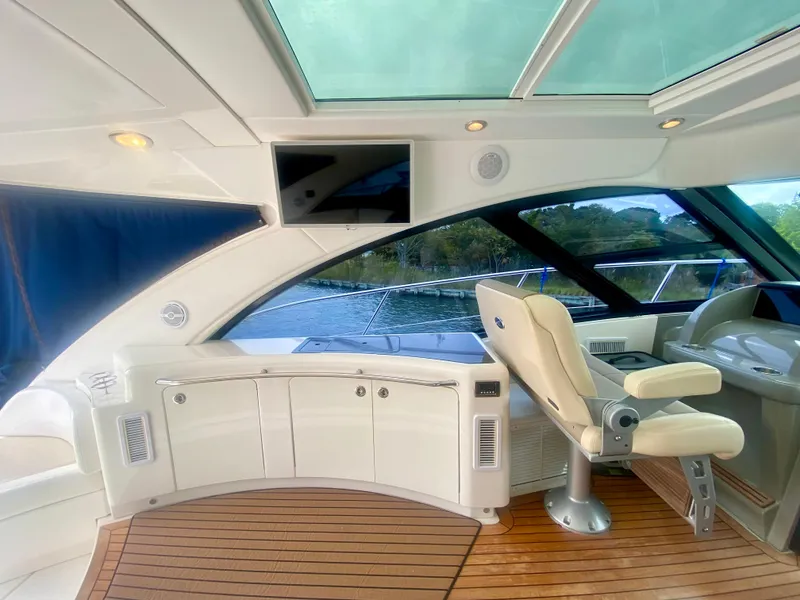 Slide: The Image of Luxurious interior of 2013 Sea Ray 580 Sundancer yacht with helm and seating area. - 33