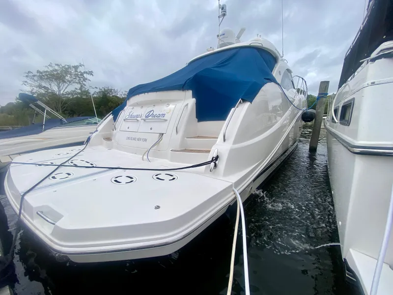 Slide: The Image of 2013 Sea Ray 580 Sundancer yacht docked with blue cover. - 12