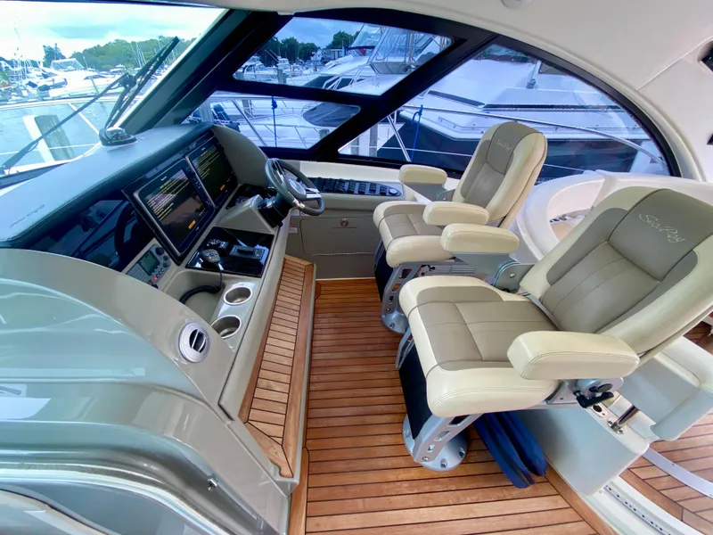 Slide: The Image of Luxurious helm of 2013 Sea Ray 580 Sundancer with leather seats and modern controls. - 42
