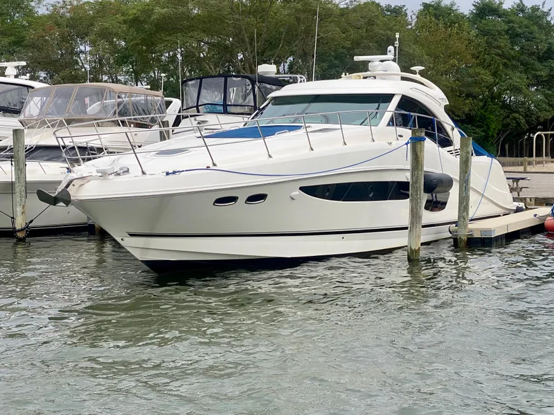 Slide: The Image of 2013 Sea Ray 580 Sundancer yacht docked in a marina. - 8