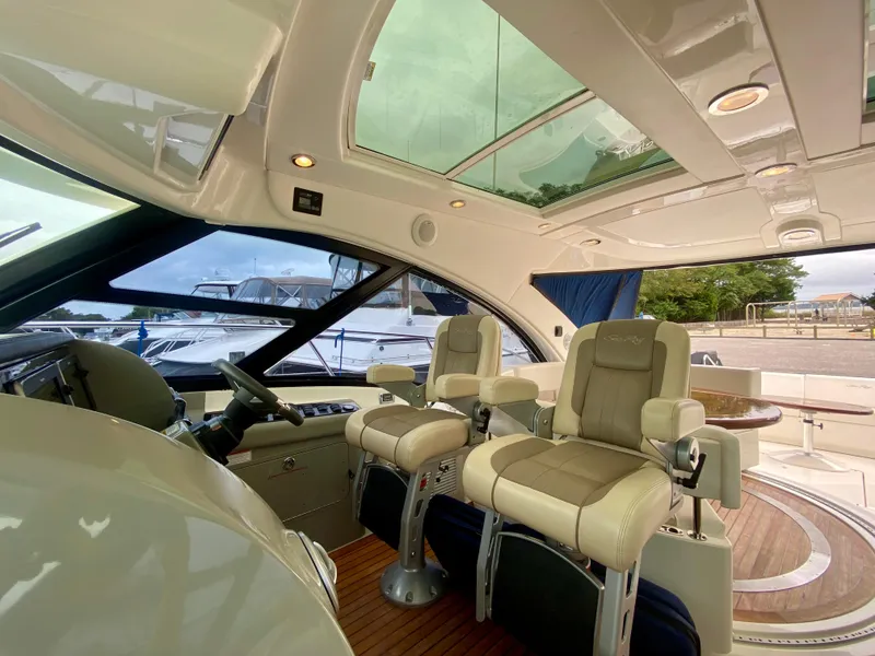 Slide: The Image of Luxurious 2013 Sea Ray 580 Sundancer yacht interior with plush seating and panoramic windows. - 35