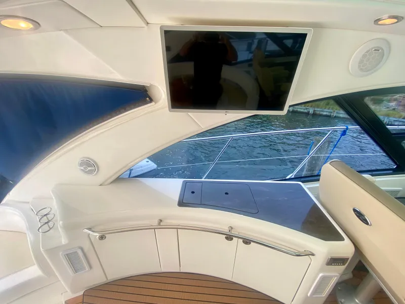 Slide: The Image of Luxurious 2013 Sea Ray 580 Sundancer yacht interior with TV and elegant seating. - 31
