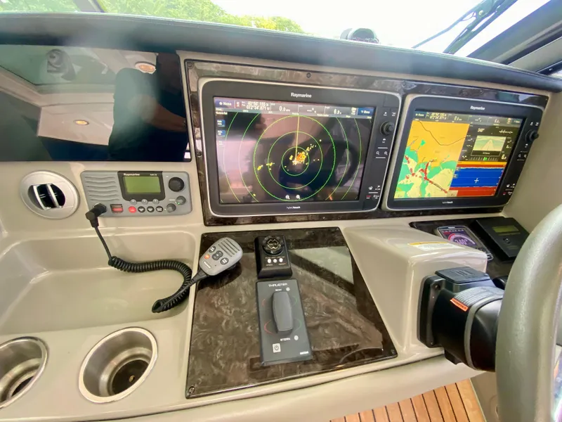 Slide: The Image of Control panel of 2013 Sea Ray 580 Sundancer with navigation screens and communication devices. - 47