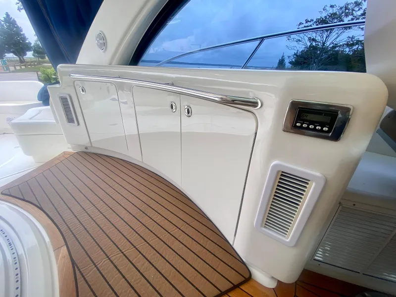 Slide: The Image of Interior view of 2013 Sea Ray 580 Sundancer yacht with sleek cabinetry and wood flooring. - 32