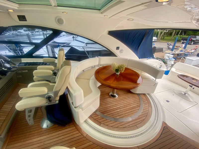 Slide: The Image of Luxurious 2013 Sea Ray 580 Sundancer yacht interior with elegant seating and wooden table. - 25