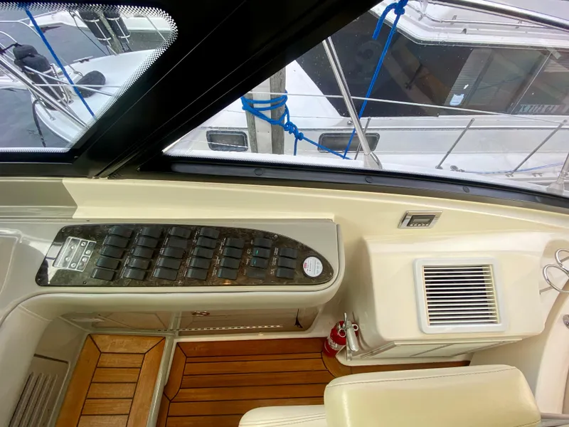 Slide: The Image of Interior view of 2013 Sea Ray 580 Sundancer yacht with control panel and wooden flooring. - 43