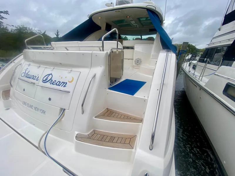 Slide: The Image of 2013 Sea Ray 580 Sundancer yacht docked, featuring "Simon's Dream" nameplate. - 17
