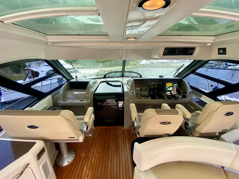 Slide: The Image of Luxurious 2013 Sea Ray 580 Sundancer yacht cockpit with leather seating and modern controls. - 40