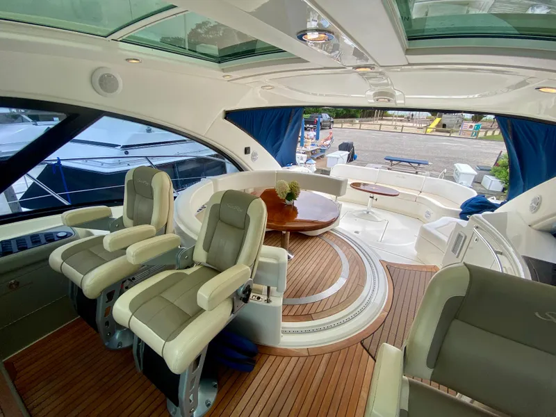 Slide: The Image of Luxurious interior of 2013 Sea Ray 580 Sundancer yacht with plush seating and wood flooring. - 38