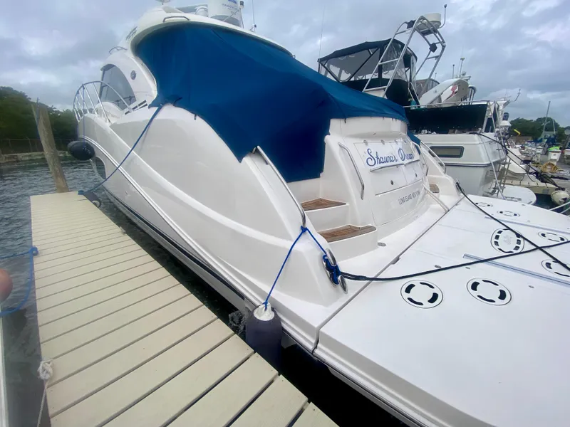 Slide: The Image of 2013 Sea Ray 580 Sundancer yacht docked with blue cover. - 13