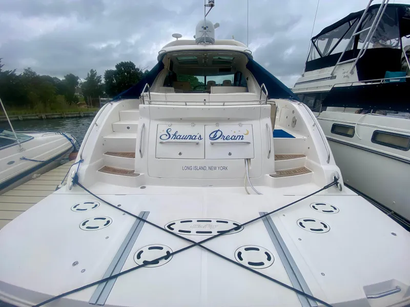 Slide: The Image of 2013 Sea Ray 580 Sundancer yacht docked, rear view with "Shawna's Dream" nameplate. - 14
