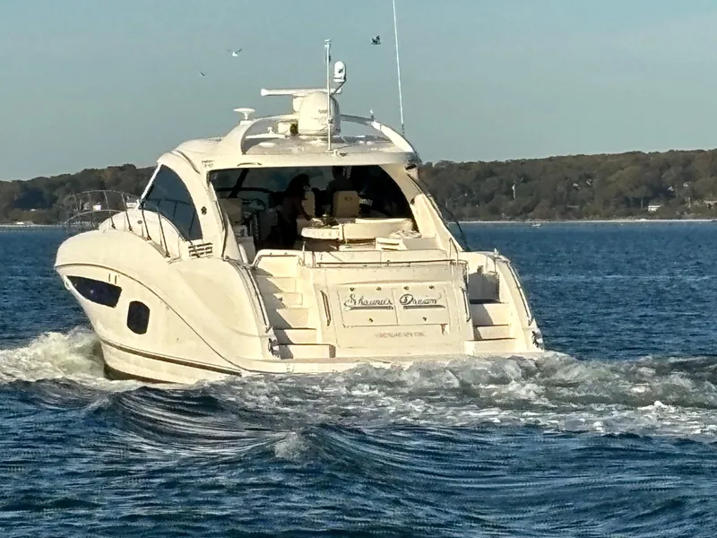 Slide: The Image of 2013 Sea Ray 580 Sundancer yacht cruising on open water. - 1