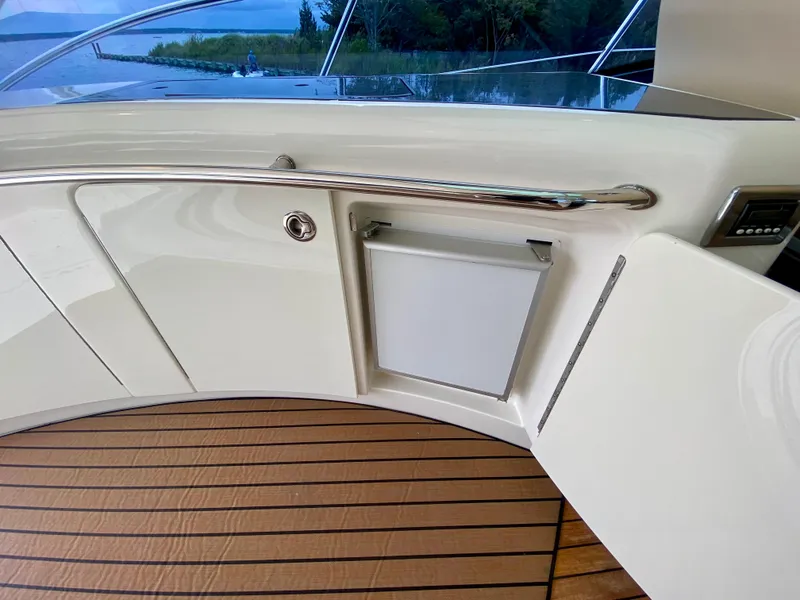Slide: The Image of 2013 Sea Ray 580 Sundancer yacht interior with sleek cabinetry and wood flooring. - 39