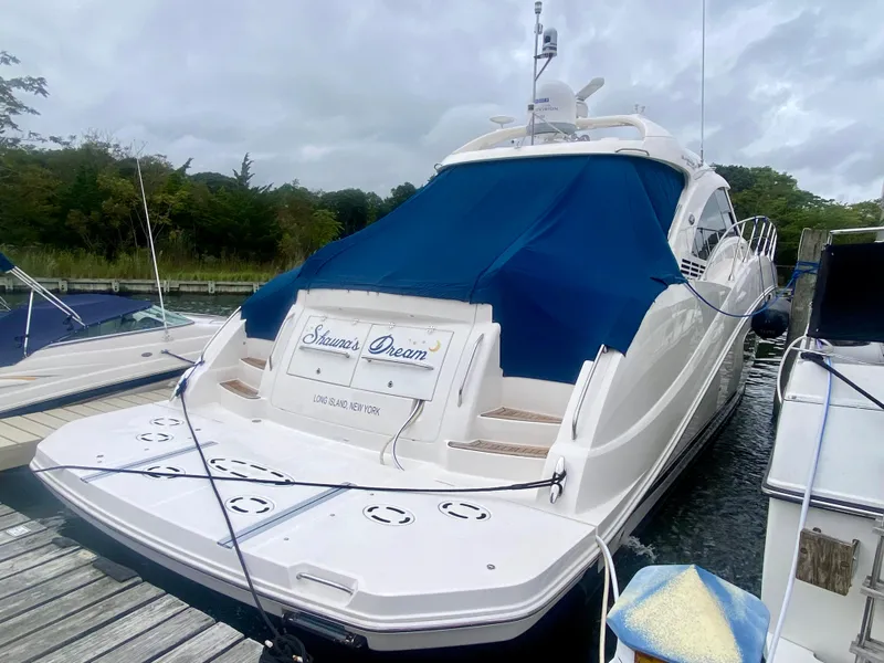 Slide: The Image of 2013 Sea Ray 580 Sundancer yacht docked with blue cover. - 11