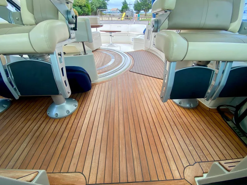Slide: The Image of Luxurious 2013 Sea Ray 580 Sundancer yacht interior with elegant wooden flooring and plush seating. - 41